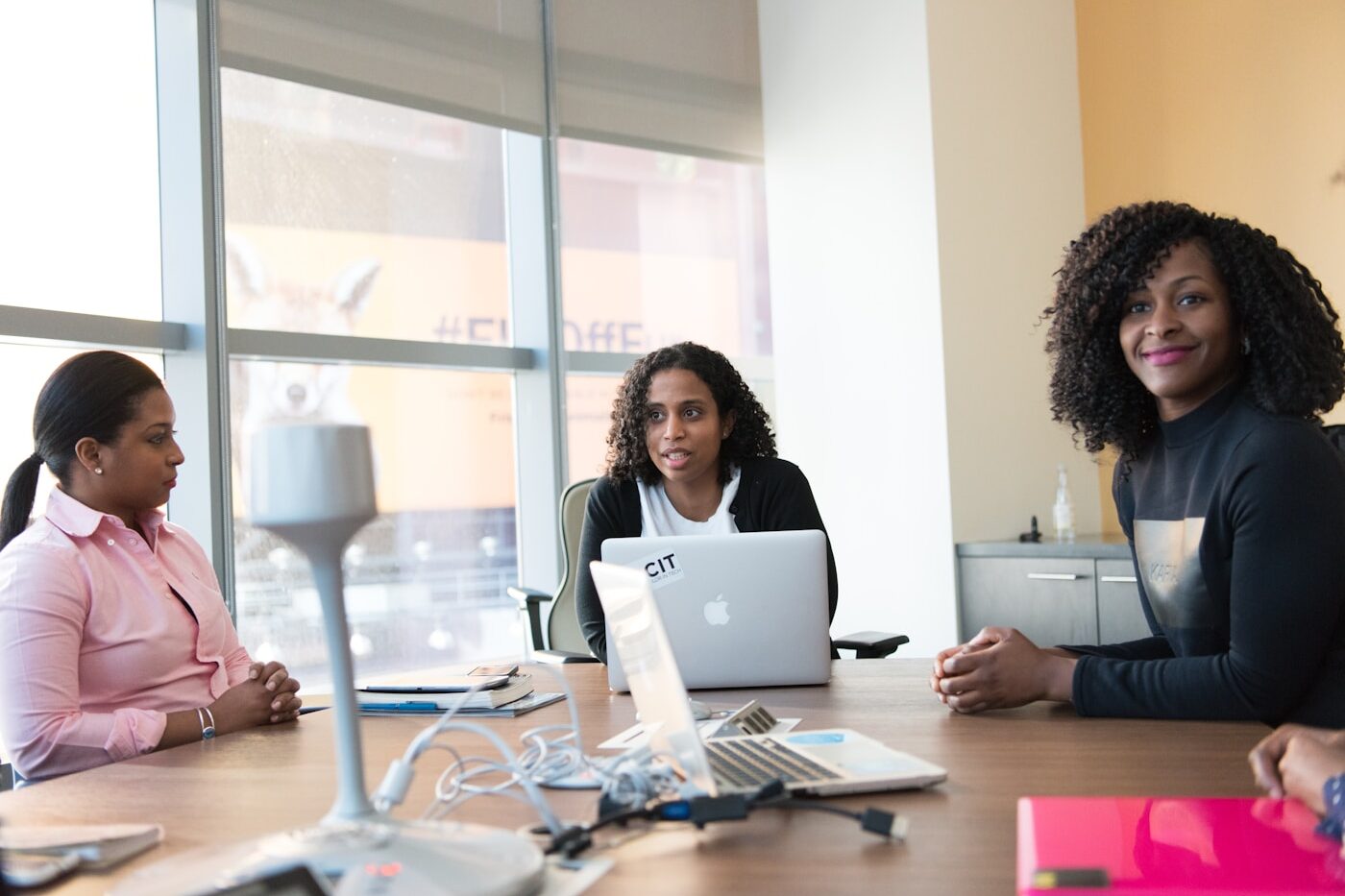 A client in consultation with loan officers around an office desk